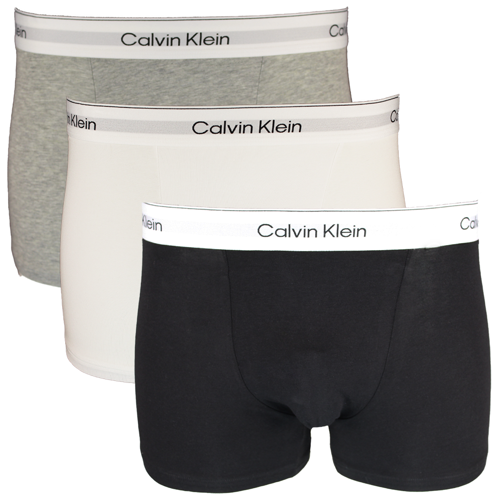 Three Calvin Klein boxer trunks in black, gray, and white on a white background.