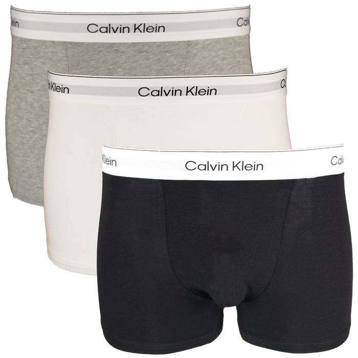 Three Calvin Klein boxer trunks in black, gray, and white on a white background.