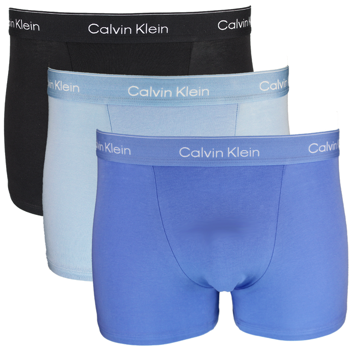 Three pairs of Calvin Klein boxer briefs in black, light blue, and dark blue on a white background.