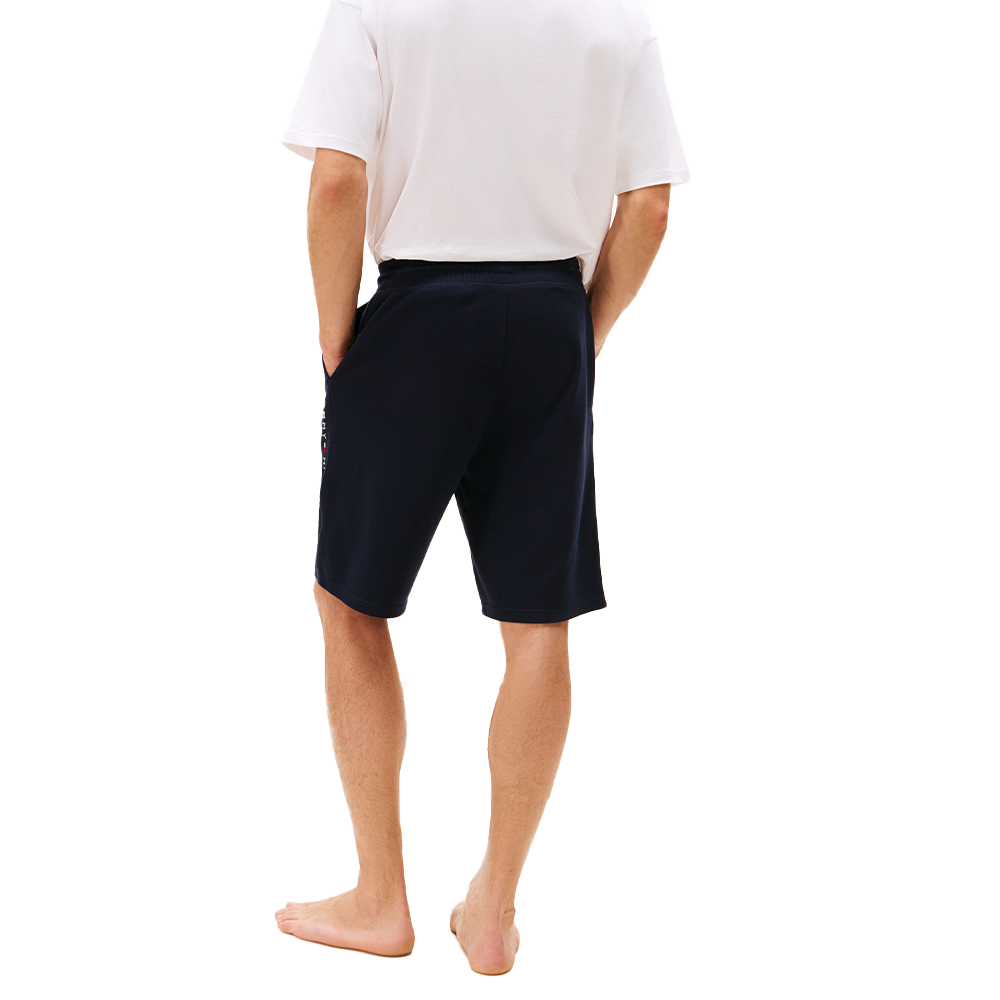 Person wearing navy shorts on a white background