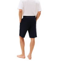 Person wearing navy shorts on a white background