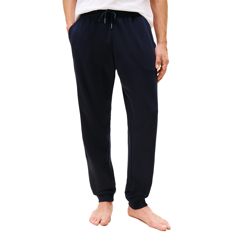 Navy blue sweatpants worn by a person on a white background